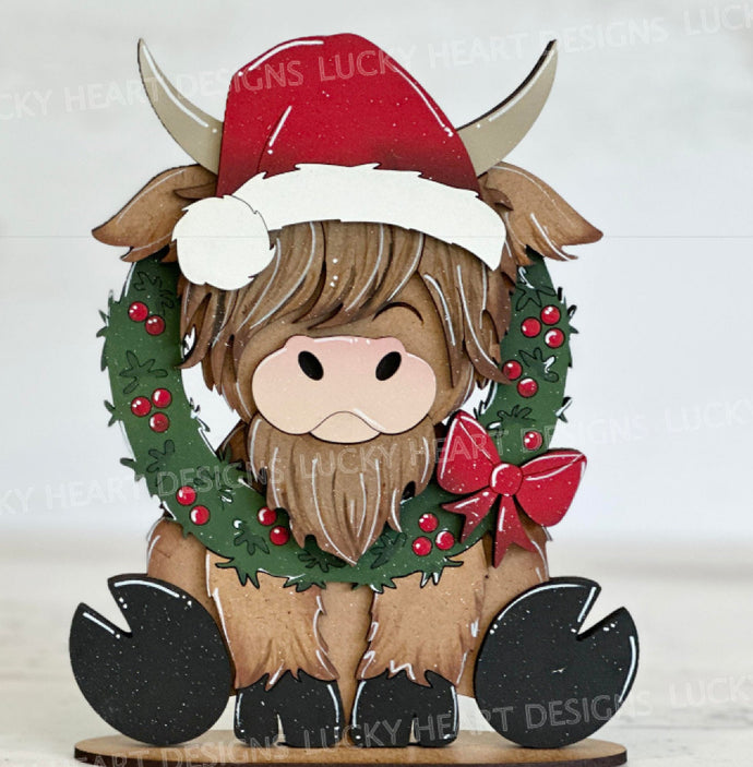 Sitting highland cow with interchangeable.