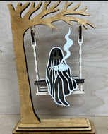 Tree with a ghost swinging.