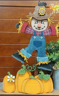 Scarecrow and pumpkins